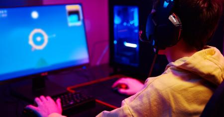 A young gamer playing video games on his home computer.