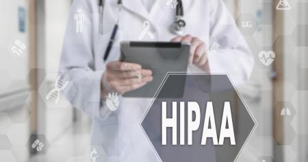 A doctor reviewing HIPAA compliance in his documents.