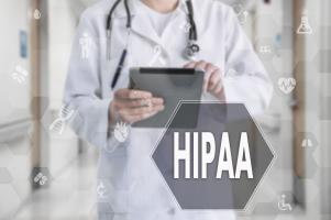 A doctor reviewing HIPAA compliance in his documents.