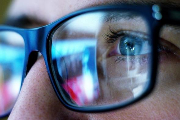 Close up of a person's glasses as they use a computer with Splashtop, the better alternative to LogMeIn